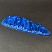 A blue, oval-shaped Used Warhammer Age of Sigmar: Prismatic Palisade Endless Spell with jagged blue spikes on a textured base.