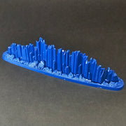 A Used Warhammer Age of Sigmar: Prismatic Palisade Endless Spell, featuring a blue, elongated crystal-like model on an oval base, displayed against a dark background.