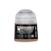 A bottle of brown Warhammer Tone Pro hobby paint with a label featuring the text CARTHALOS SKIN and a circular icon highlighting the number five.