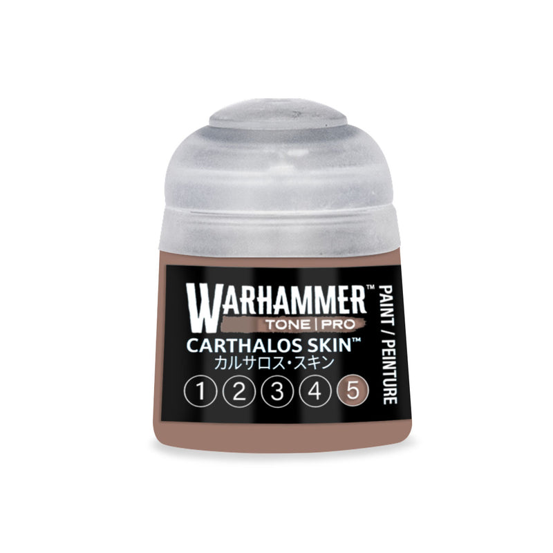 A bottle of brown Warhammer Tone Pro hobby paint with a label featuring the text CARTHALOS SKIN and a circular icon highlighting the number five.