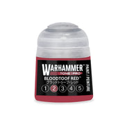 A small Warhammer Tone Pro plastic bottle of Bloodtoof Red paint, featuring a label with a row of numbered circles from one to five.