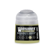 A small plastic pot of Warhammer Tone Pro acrylic paint in Kruleboyz Green, featuring a gray cap, a black label with the text Kruleboyz Green, and a row of numbers from one to five.