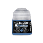 A small blue Warhammer Tone Pro paint pot with a translucent cap, labeled Ultramar Blue and featuring a scale of numbers one through five with the number three circled.