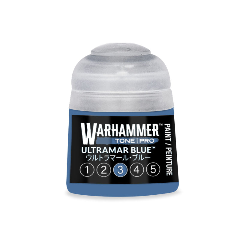 A small blue Warhammer Tone Pro paint pot with a translucent cap, labeled Ultramar Blue and featuring a scale of numbers one through five with the number three circled.