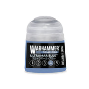 A small plastic pot of Warhammer Tone Pro Ultramar Blue hobby paint, featuring a row of numbered circles from one to five at the bottom of the label.