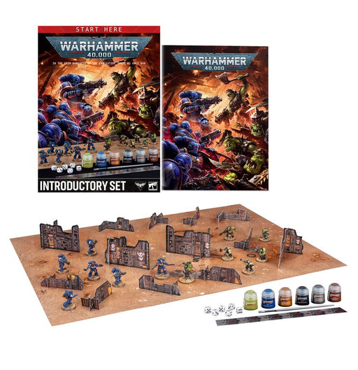 The Warhammer 40k: Introductory Set features two guides, painted miniatures, dice, cards, paint pots, and a desert-themed battlefield complete with terrain pieces.