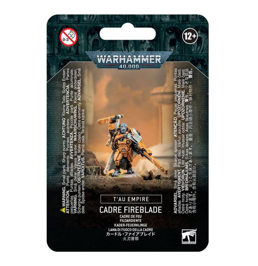 Packaging for the Warhammer 40k: Tau Empire Cadre Fireblade plastic kit by Games Workshop, featuring an image of the painted miniature wielding a gun and sword, with multilingual text. Recommended for ages 12 and up.