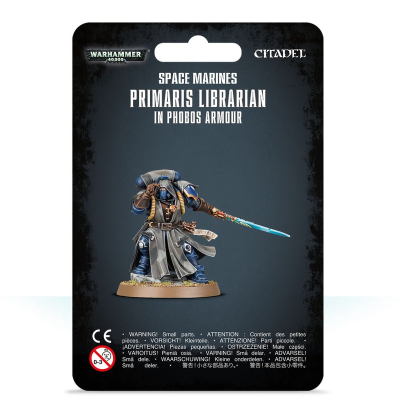 A Warhammer 40k: Space Marines Primaris Librarian in Phobos Armour package features an image of the painted miniature wielding a glowing sword and staff, with product and safety information shown beneath.