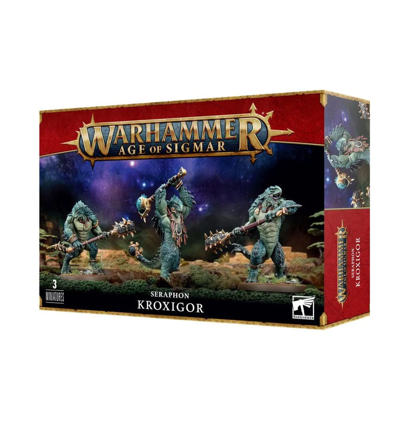 The Warhammer Age of Sigmar: Seraphon - Kroxigor box by Games Workshop shows three reptilian miniatures with weapons, set against a cosmic backdrop and official product branding.