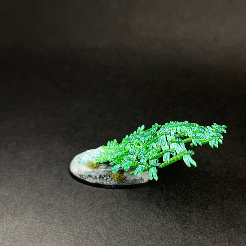 A painted and based Used Warhammer AOS: Endless Spells Emerald Lifeswarm model with a detailed emerald creature on a gray base.