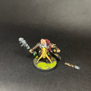 A painted Used Warhammer Age Of Sigmar: Ogor Mawtribes - Icebrow Hunter (L2) stands on a grassy base with a red mane and spiked club, accompanied by a detailed accessory on the dark surface beside him.