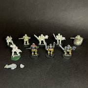 A group of painted and unpainted Used Warhammer 40k: Space Marines - Scouts, including old metal models, arranged in two rows on a dark surface with loose bits like a hand and gun in front.