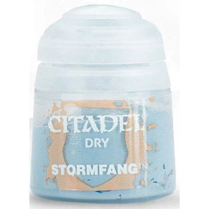 The 12ml Citadel Dry Paints: Stormfang is a light blue drybrushing paint in a small plastic pot with a clear lid and gold-and-white label, ideal for creating weathered effects.