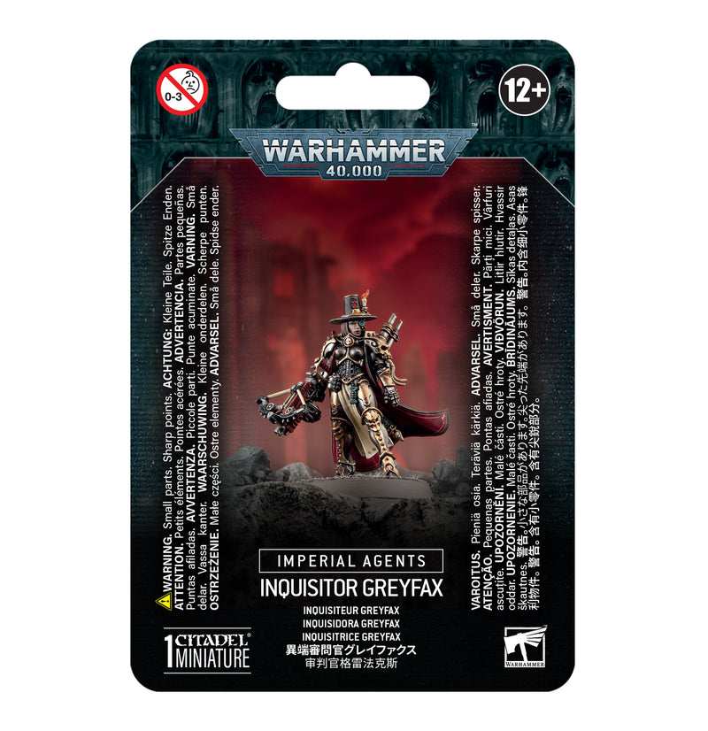 The Warhammer 40k: Imperial Agents - Inquisitor Greyfax packaging shows a painted, armored figure with sword and pistol. Includes Games Workshop info, a Citadel 32mm Round Base, and is suitable for ages 12+.