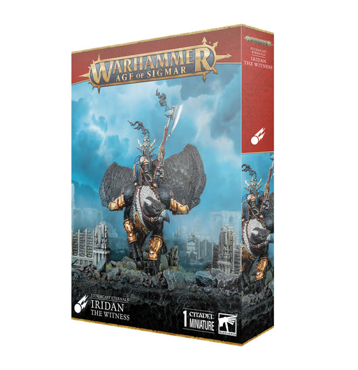 Box of Warhammer Age of Sigmar: Stormcast Eternals - Iridan the Witness, featuring a detailed miniature of Iridan the Witness, a fantasy warrior mounted on a winged creature above ancient ruins with dramatic blue clouds in the background. Includes plastic components and a Citadel 120mm Oval Base. Produced by Games Workshop.