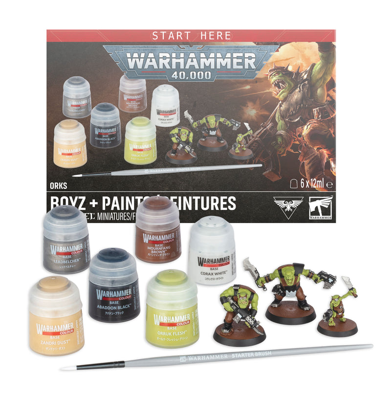 Warhammer 40k: Orks - Boyz + Paints includes paint pots, assembled Orks Boyz miniatures, a paintbrush, and a display box featuring product details and artwork of Ork warriors.
