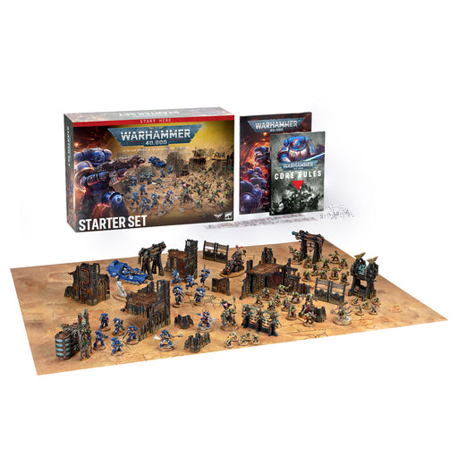 Warhammer 40k: Starter Set with box, rulebook, and assembled painted miniatures displayed on a detailed battlefield mat complete with terrain and accessories from Games Workshop.