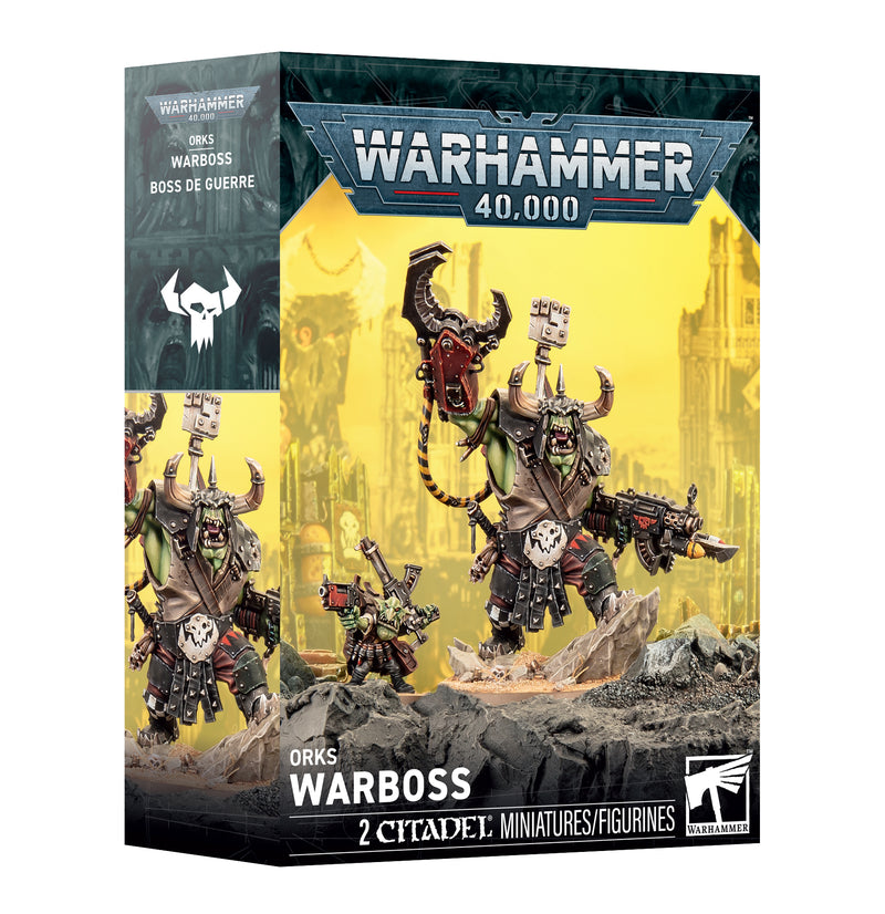 Warhammer 40k: Orks - Warboss by Games Workshop, featuring two assembled and painted Orks Warboss miniatures displayed before a backdrop of a ruined, yellow-tinted cityscape.