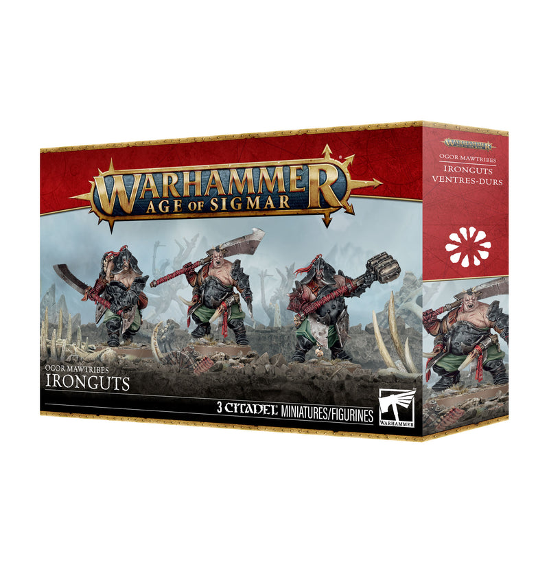 The Warhammer Age of Sigmar: Ogor Mawtribes - Ironguts box, featuring three assembled Ogor miniatures wielding massive weapons, displayed on a rocky, bone-strewn battlefield. This customizable kit from Games Workshop includes Citadel 40mm Round Bases and full product branding and details.