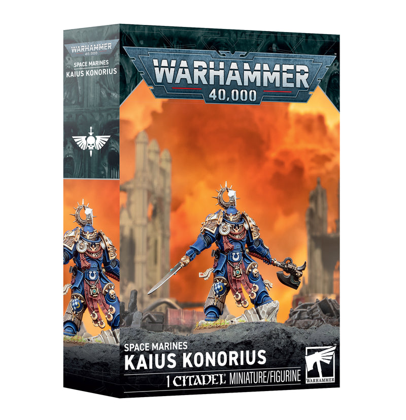 Warhammer 40k: Space Marines - Kaius Knorius box, showcasing the painted figure in blue armor with gold accents, set against a backdrop of a fiery, ruined landscape.