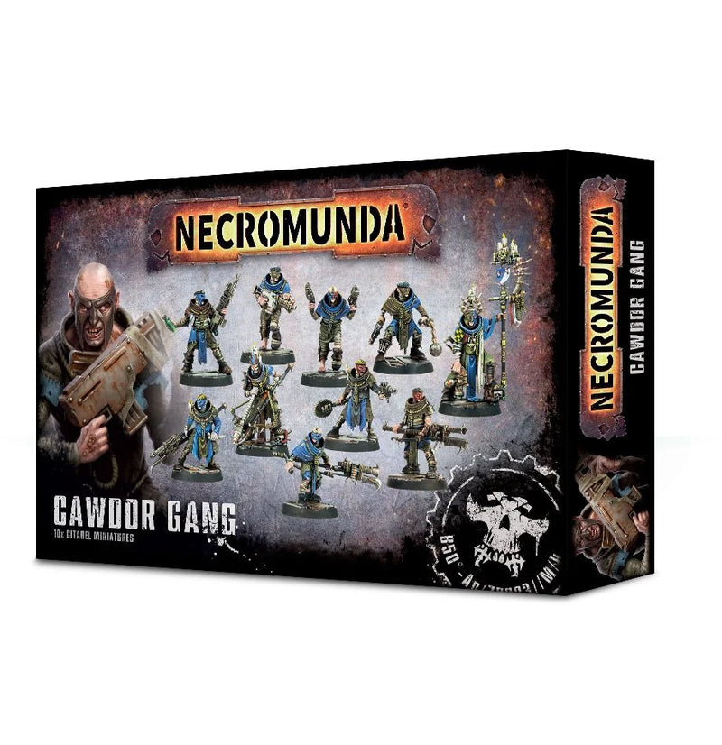 A box of Necromunda: Cawdor Gang miniatures is displayed, featuring painted plastic models and packaging artwork depicting a character wielding a large weapon.