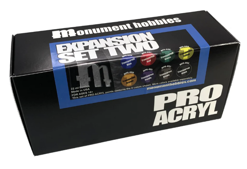 A black box labeled Monument Hobbies Pro Acryl Paint: Expansion Set #2 – Transparents – 9 Colors, with nine transparent paint bottles.