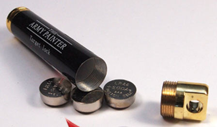 A small black and gold tube labeled "Army Painter: Markerlight Laser Pointer" with its cap off, showing round metal batteries on a white surface—ideal for wargaming setups or as a handy accessory.