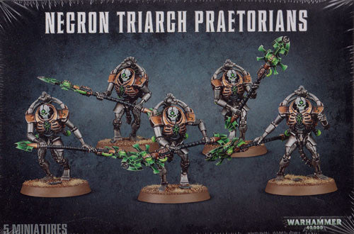 Five painted miniatures from the Warhammer 40k: Necron Lychguard/Triarch Praetorians set by Games Workshop stand in dynamic poses, wielding glowing green weapons on a rocky terrain base against a dark background.