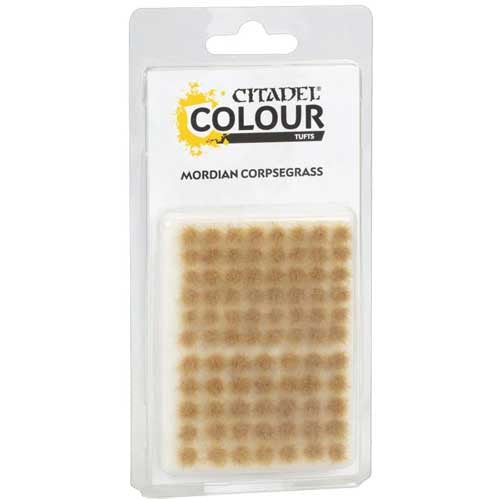 A clear plastic package labeled Citadel Colour Tufts: Mordian Corpsegrass, containing brownish grassy tufts ideal for miniature basing.