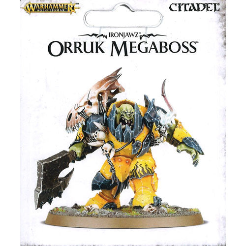 A painted plastic Ironjawz Orruk Megaboss miniature from Warhammer Age of Sigmar stands on a 60mm base with spikes and bones, packaged with Citadel and Games Workshop branding.