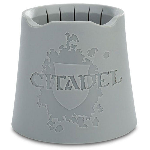The Citadel Water Pot is a gray plastic pot with vertical slits at the top and an embossed Citadel logo, ideal for use with Games Workshop hobby supplies.