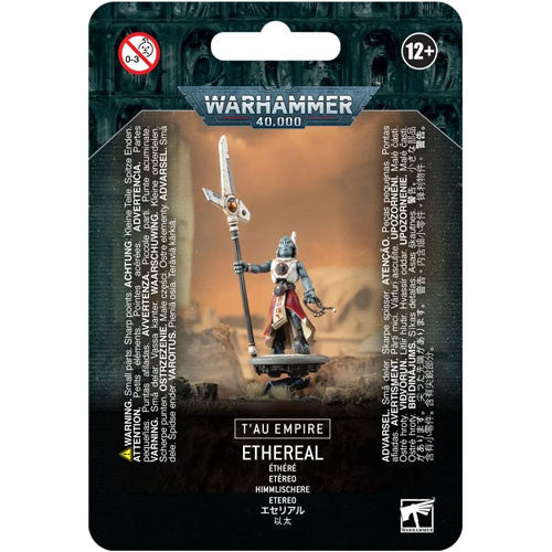 The Warhammer 40k: Tau Empire - Ethereal blister pack by Games Workshop contains an unpainted Ethereal miniature with a staff, features multilingual warnings, and is recommended for ages 12 and up.